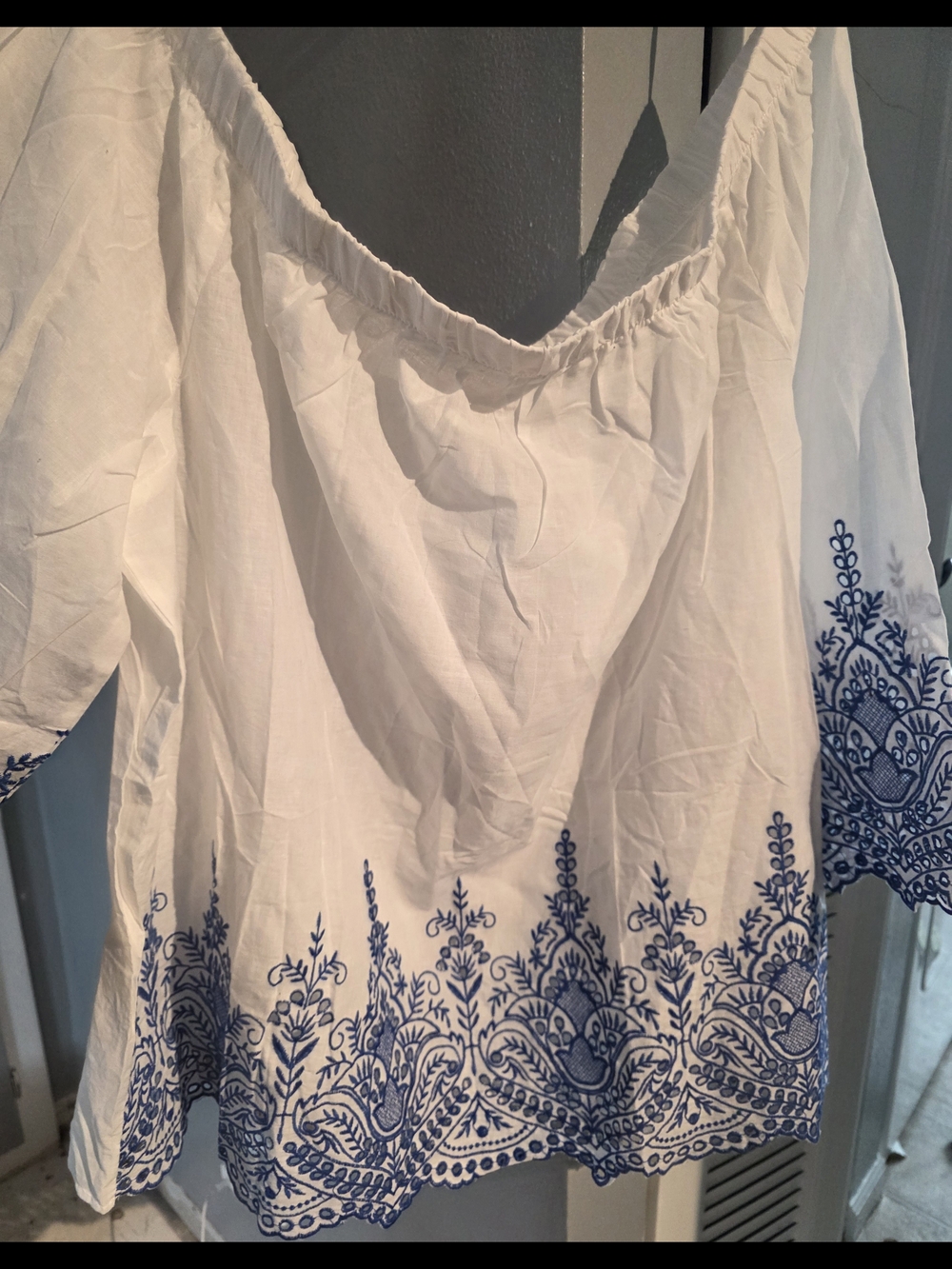 White Off-Shoulder Blouse with Blue Embroidered Hem